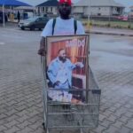 Nigerian Man Calls Davido A Good Man As He Roams The Streets With Singer’s Portrait (Video)